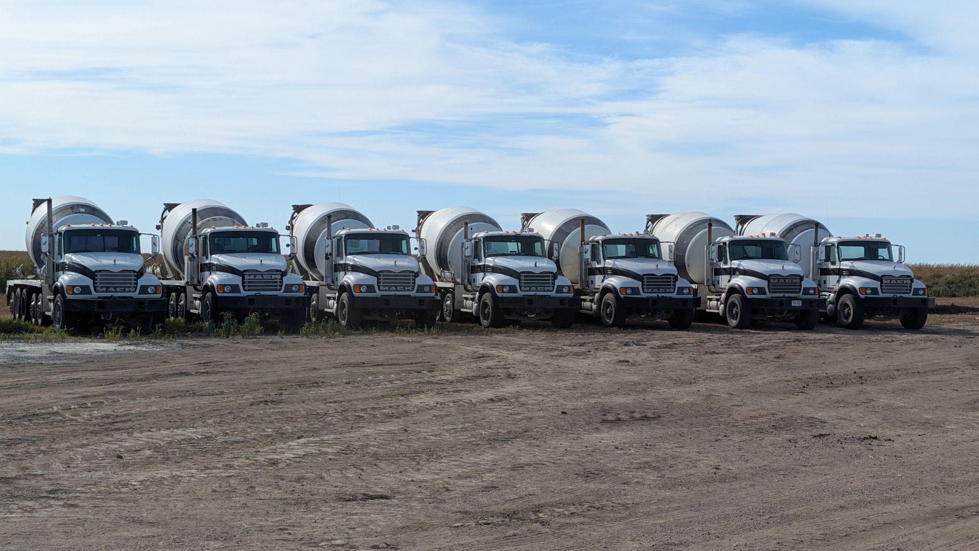 Mack mixer trucks parked at an angle on the plant yard.